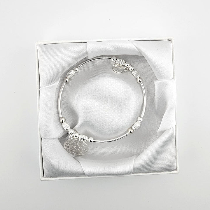 Sterling silver oval bead bracelet with heart charm.