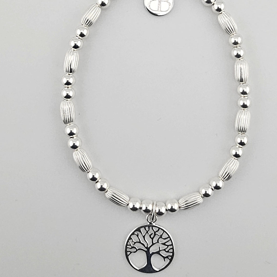 Sterling silver Tree of Life bracelet with corrugated oval beads.