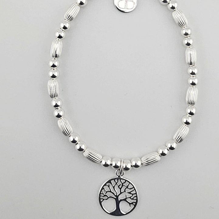 Sterling silver Tree of Life bracelet with corrugated oval beads.