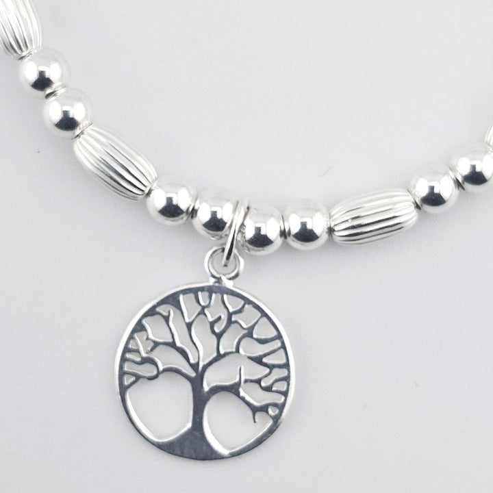 Elegant silver bracelet symbolising growth and harmony.