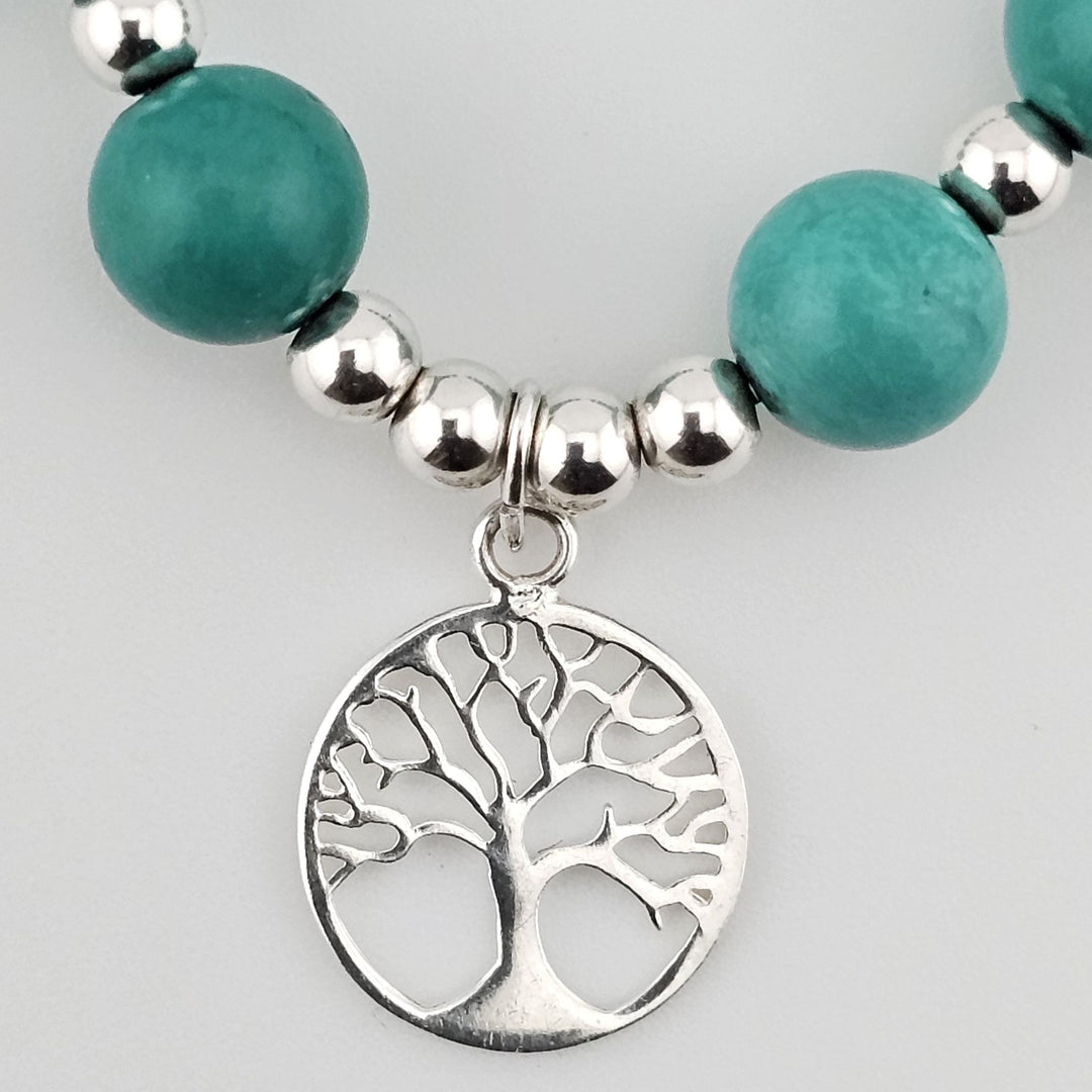 Healing turquoise beaded bracelet with symbolic Tree of Life pendant.