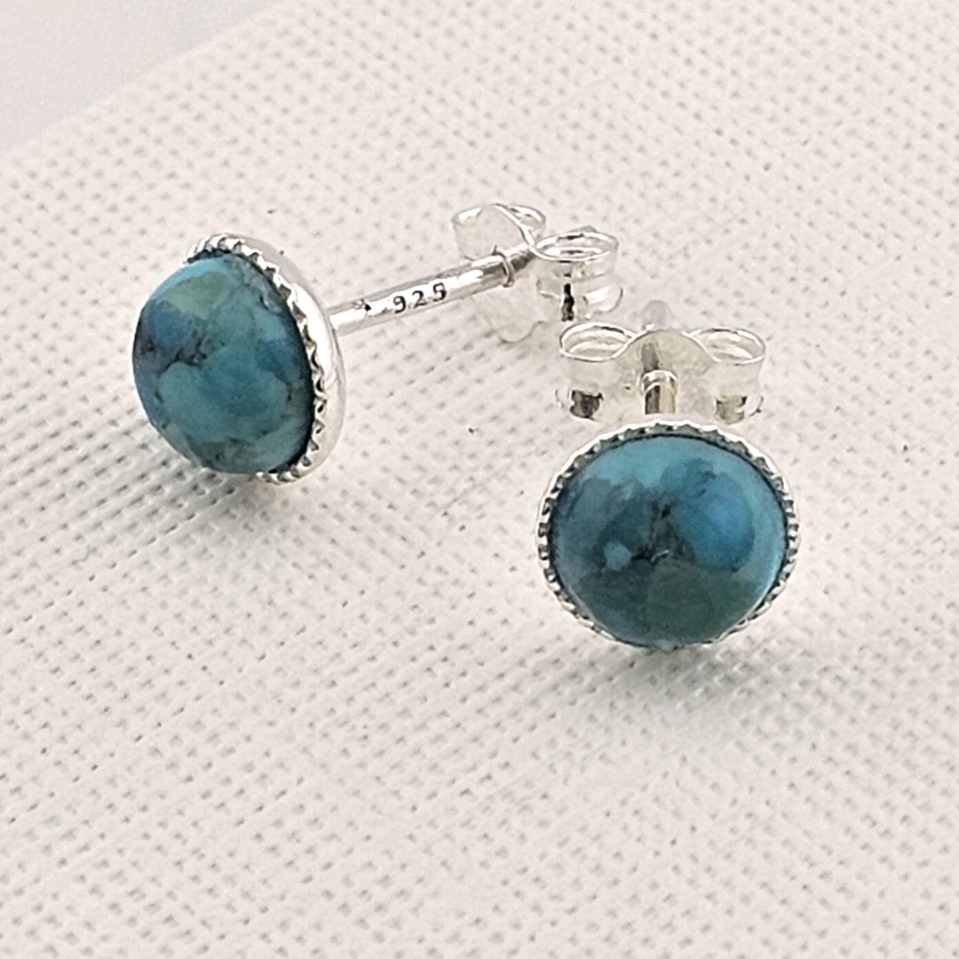 Pair of Bessie Bae handmade turquoise sterling silver stud earrings on a white background.