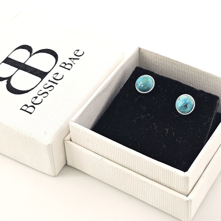 Turquoise sterling silver earrings in a Bessie Bae gift box on a white background.