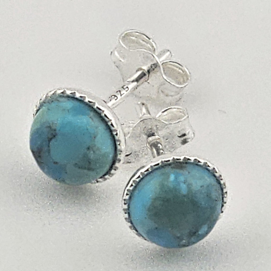 Turquoise stone Bessie Bae earrings with sterling silver settings on a light grey background.