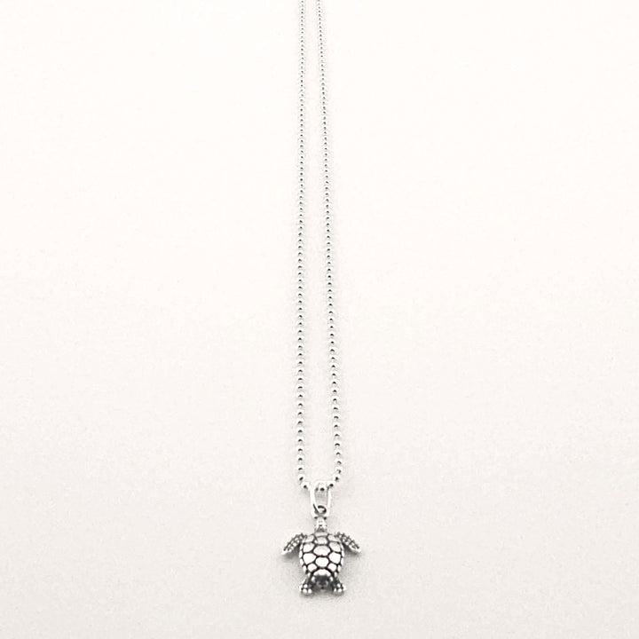 Sterling silver turtle pendant necklace on fine chain.