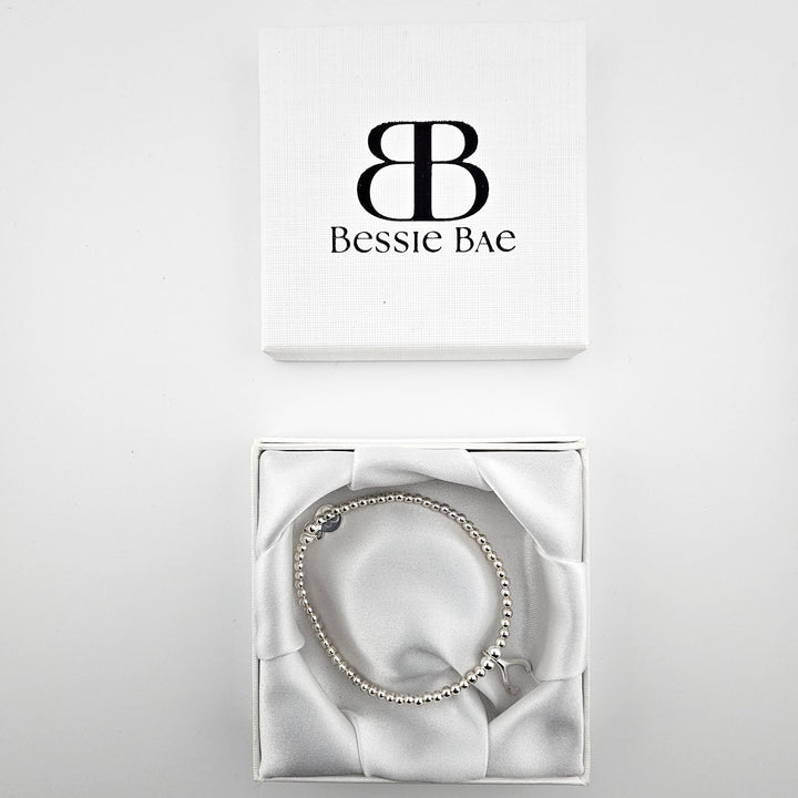 Sterling silver wishbone charm bracelet in Bessie Bae gift box.