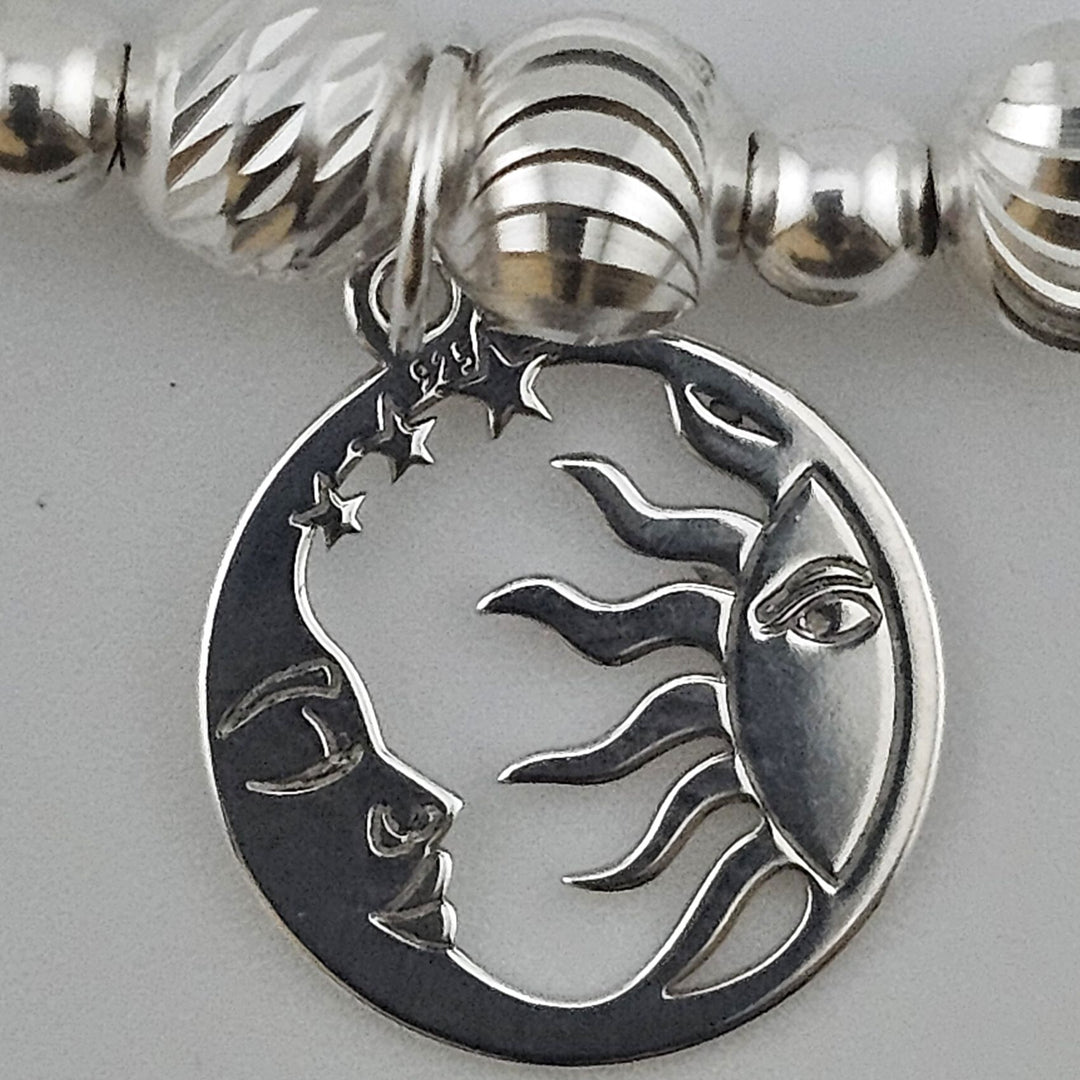 Close-up of Sterling Silver Sun and Moon charm on bracelet.