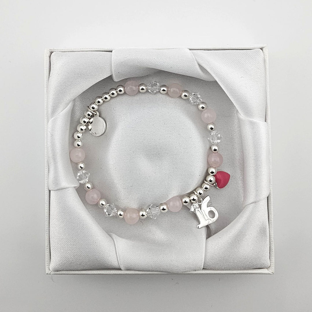 Bessie Bae packaging with Sterling Silver 16 charm bracelet presented in white satin box.