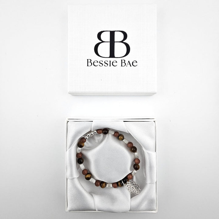 Tiger’s eye and goldstone bracelet with lotus charm in Bessie Bae gift box.