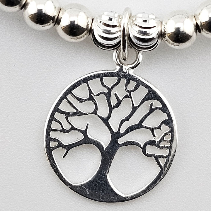 Close-up of Tree of Life charm on sterling silver and aventurine bracelet.