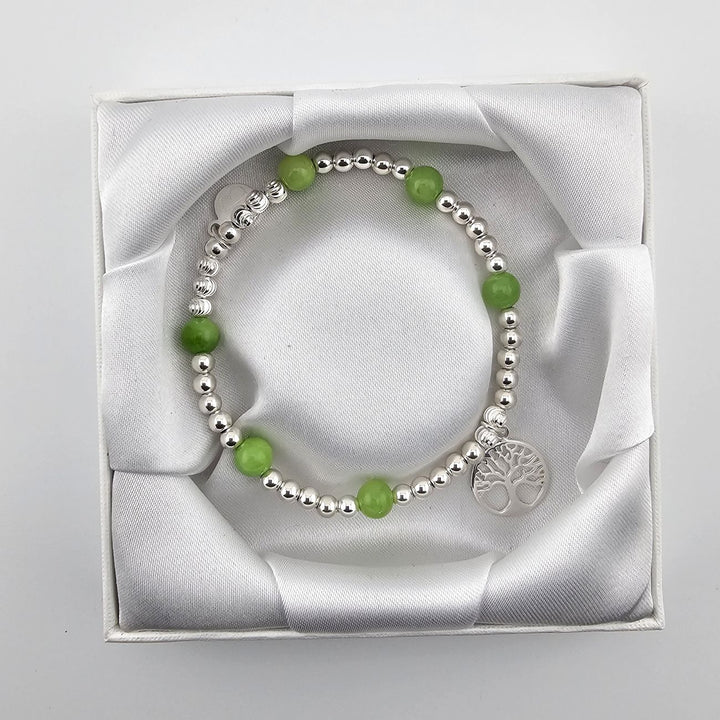 Top view of silver and aventurine Tree of Life bracelet in box.
