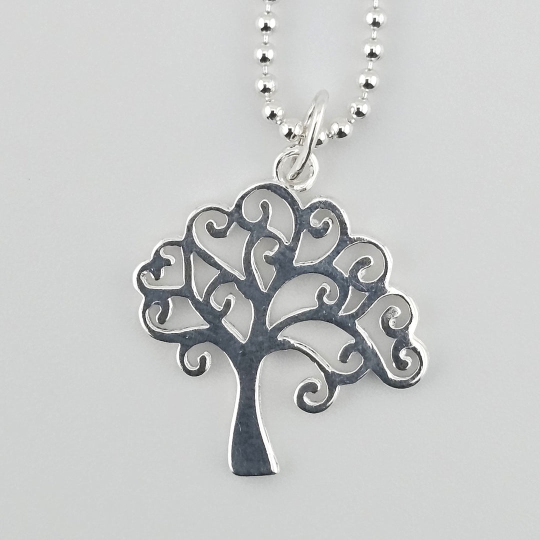 Close up of Tree of Life charm in 925 sterling silver with intricate swirling branches.