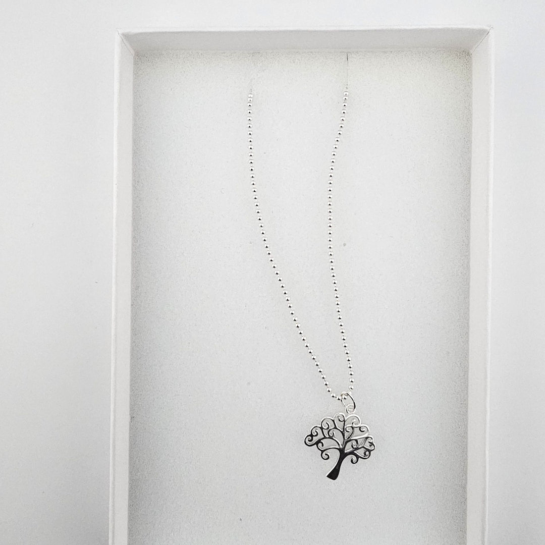 Tree of Life sterling silver necklace displayed in a white gift box.