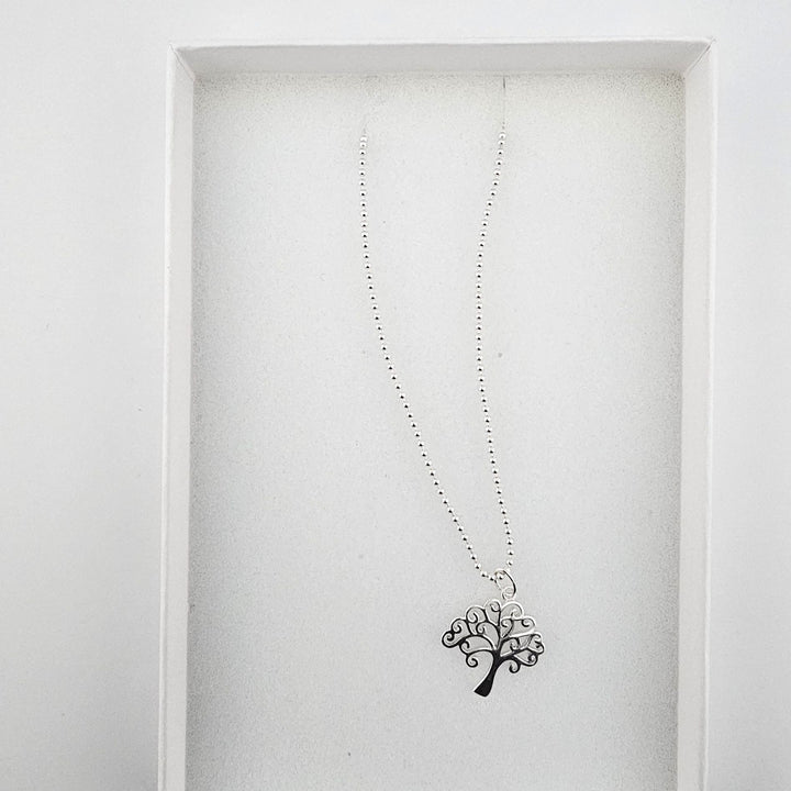 Tree of Life sterling silver necklace displayed in a white gift box.